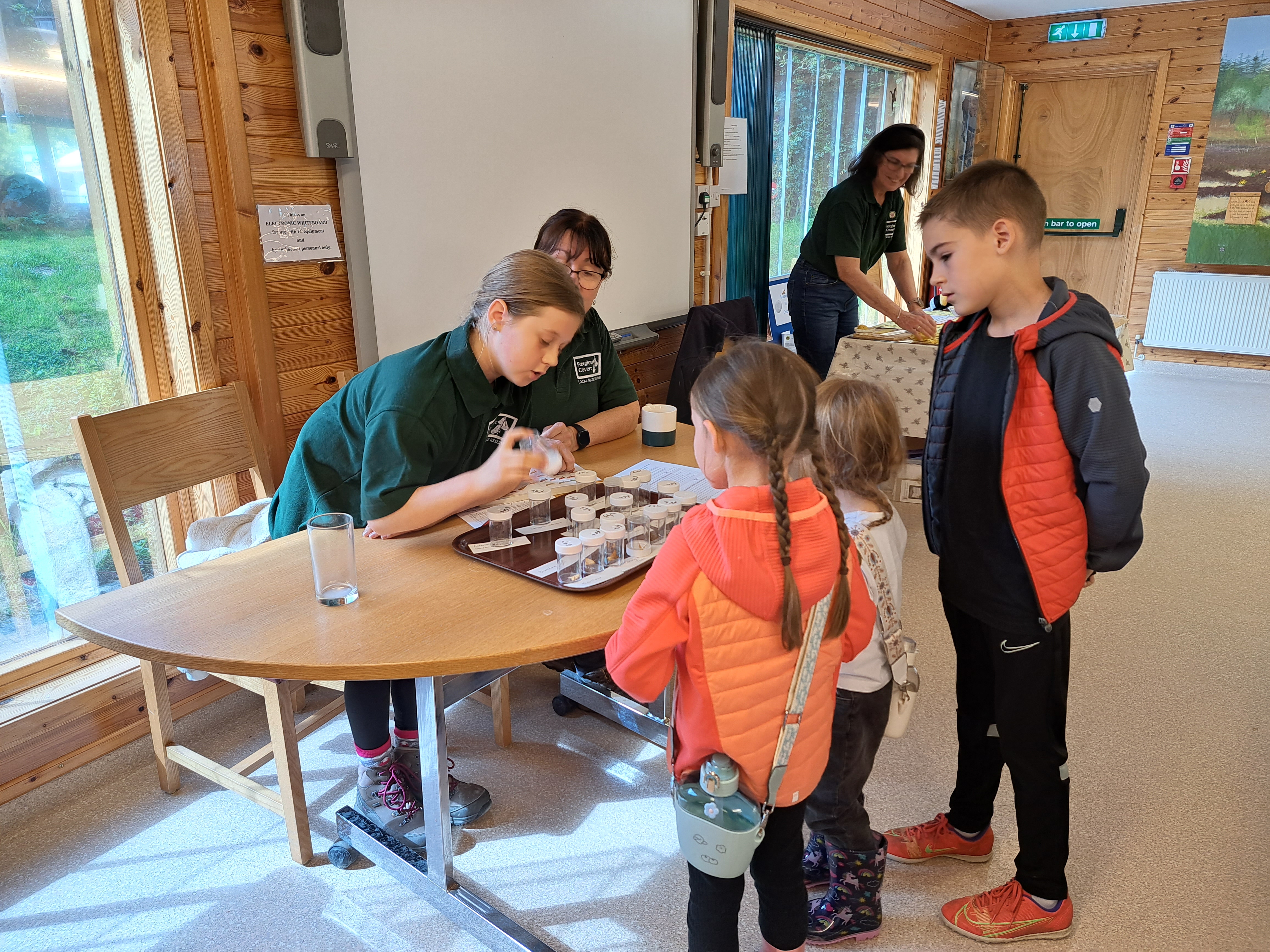 Attendees at our Family Discovery Day getting expert help on moths from one of our younger volunteers!